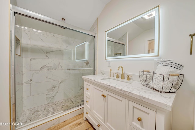 full bath with a shower stall, visible vents, wood finished floors, and vanity