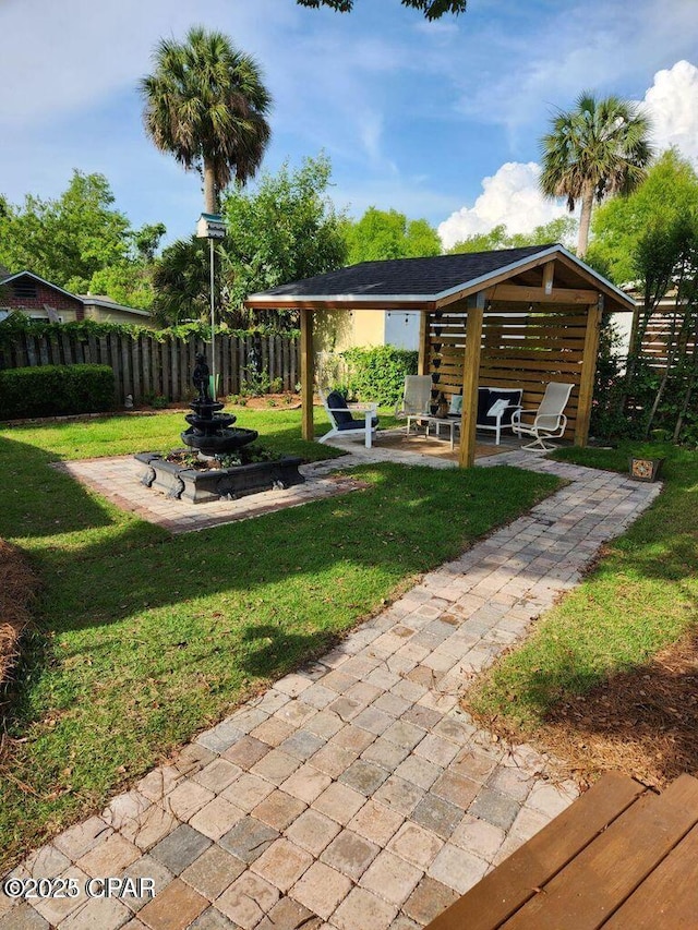 view of yard featuring fence and a patio