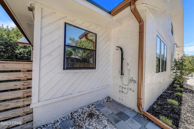 view of side of property with stucco siding