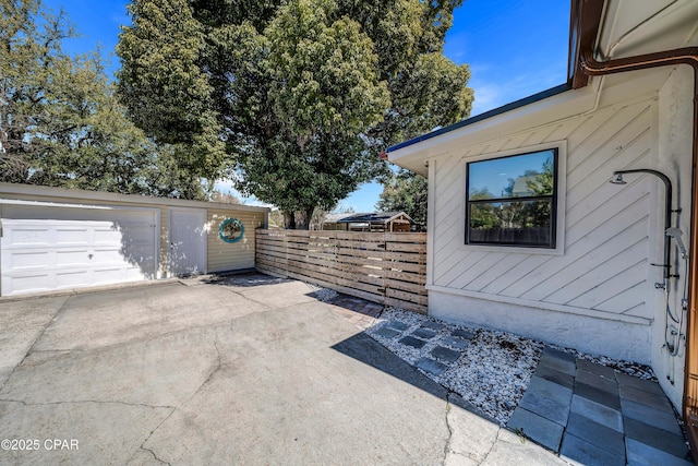 exterior space with a garage, fence, and driveway