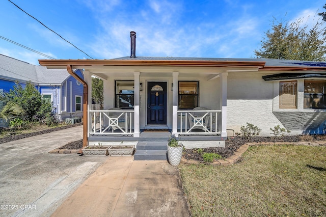 view of front of house with a porch and stucco siding