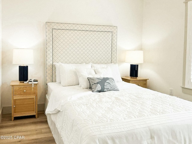 bedroom featuring wood finished floors