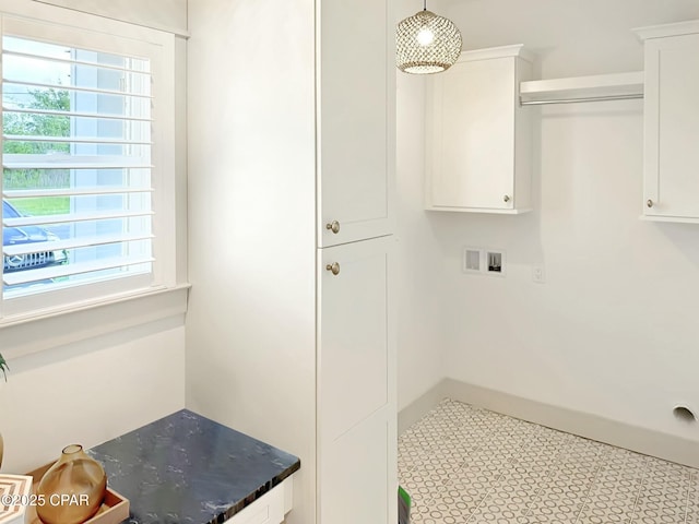 clothes washing area with cabinet space and hookup for a washing machine