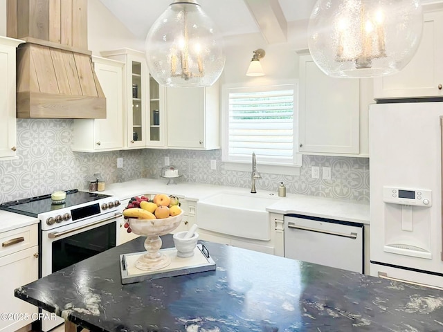 kitchen with tasteful backsplash, glass insert cabinets, white appliances, white cabinetry, and a sink