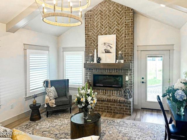 living room featuring a fireplace, lofted ceiling with beams, wood finished floors, and baseboards