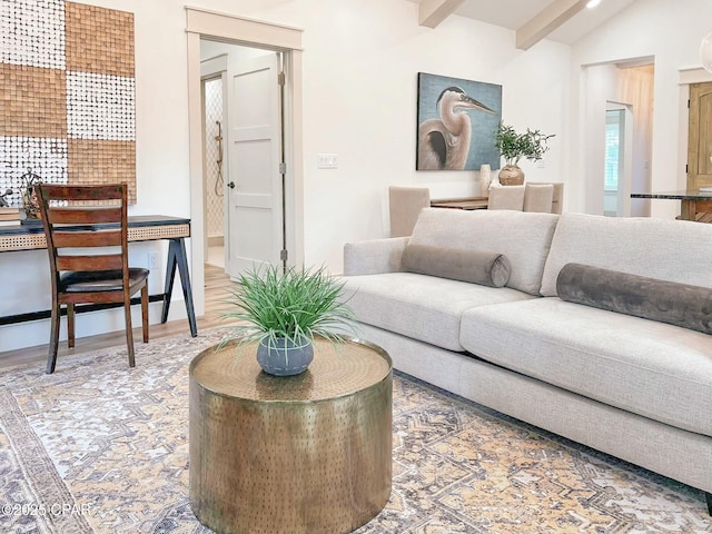 living room with lofted ceiling with beams and wood finished floors