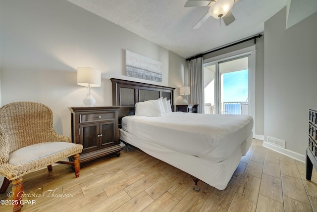 bedroom featuring light wood-type flooring, visible vents, a ceiling fan, access to outside, and baseboards