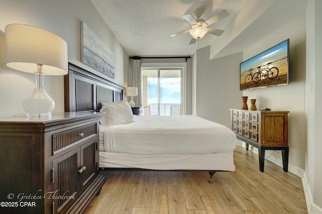 bedroom with wood finished floors, baseboards, and ceiling fan