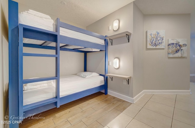 unfurnished bedroom featuring baseboards and wood finished floors