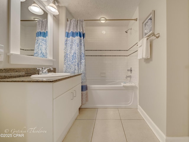 bathroom featuring vanity, baseboards, shower / tub combo, a textured ceiling, and tile patterned floors