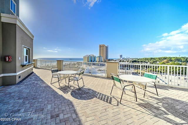 view of patio / terrace featuring outdoor dining space and a water view