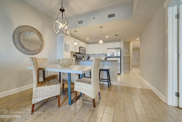 dining space featuring recessed lighting, visible vents, baseboards, and wood tiled floor