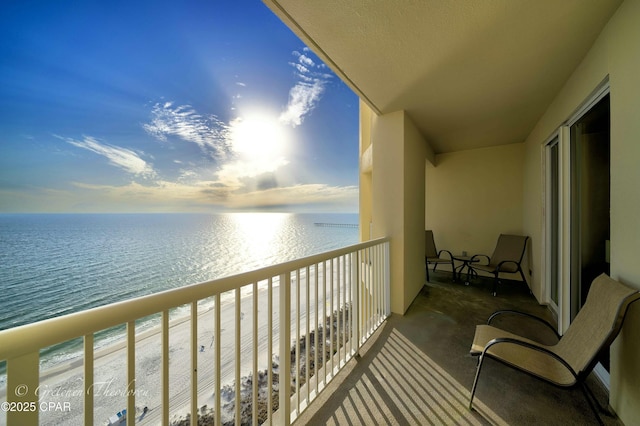 balcony with a beach view and a water view