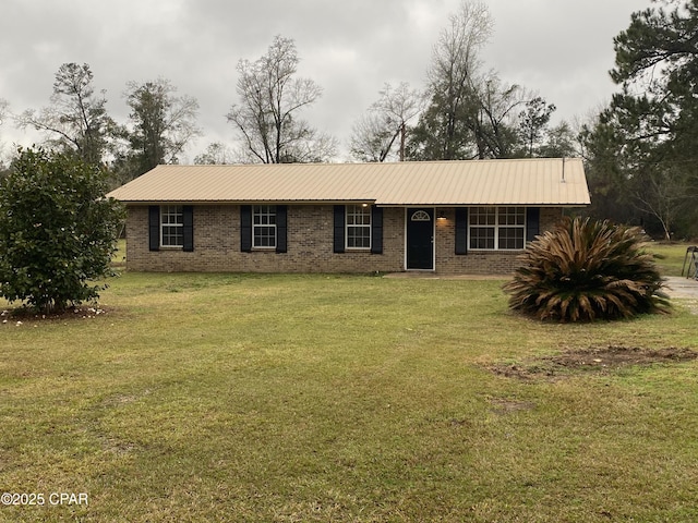 ranch-style house with a front yard, brick siding, and metal roof