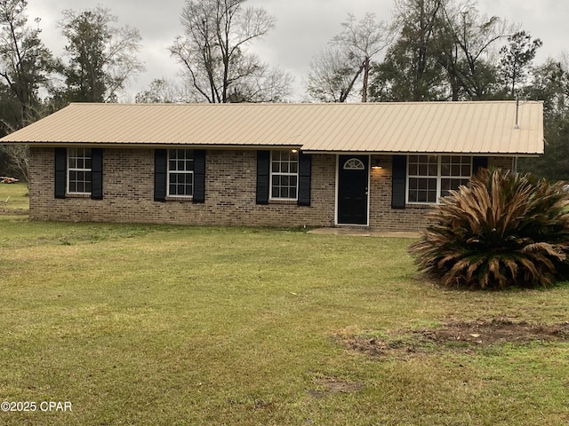 ranch-style house with a front lawn, brick siding, and metal roof