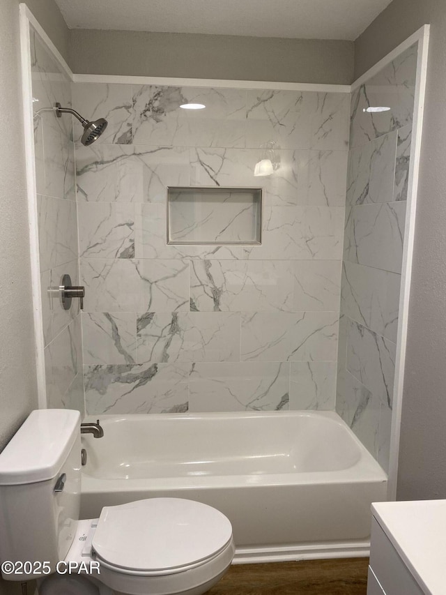 bathroom featuring vanity,  shower combination, toilet, and wood finished floors