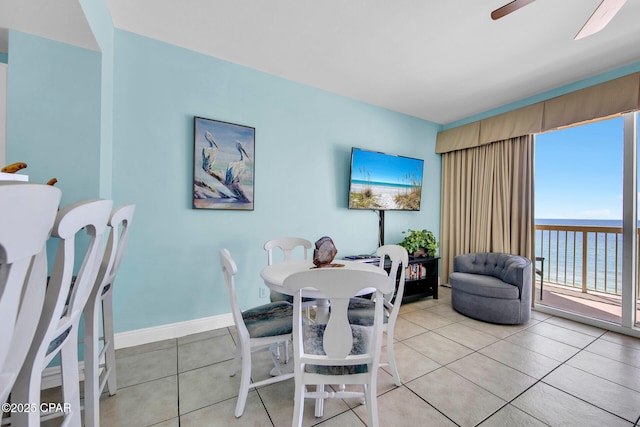 dining room with light tile patterned floors, baseboards, and ceiling fan