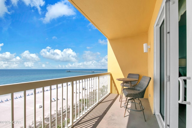 balcony with a beach view and a water view