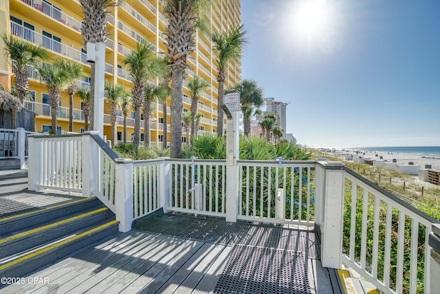 wooden terrace featuring a water view