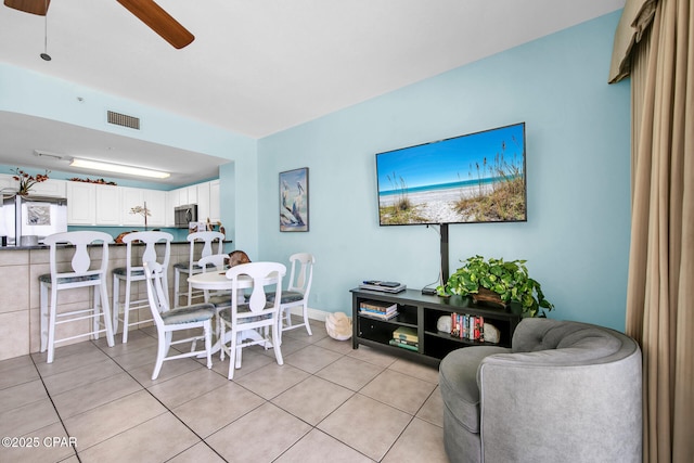 dining area featuring light tile patterned floors, visible vents, and ceiling fan