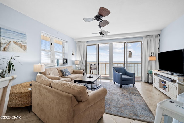 living area with light tile patterned floors and ceiling fan