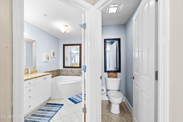 bathroom with toilet, tile patterned flooring, baseboards, a bath, and vanity