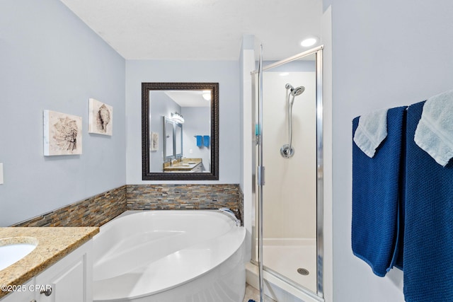 bathroom with vanity, a shower stall, and a bath