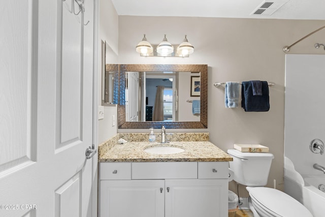 bathroom featuring vanity, toilet, visible vents, and shower / bathtub combination