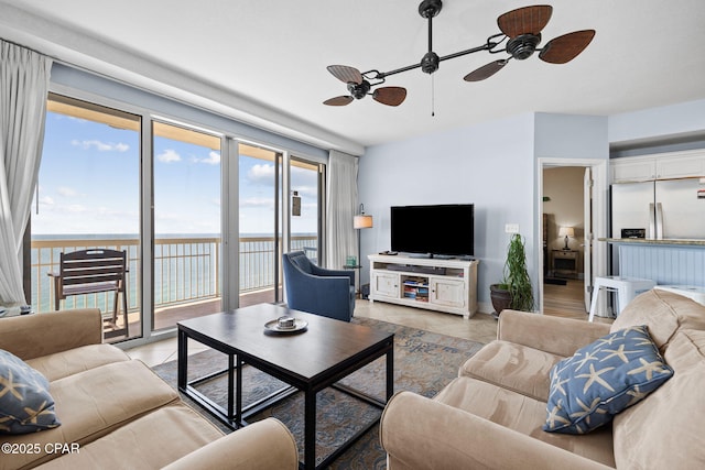 living room with ceiling fan and light tile patterned flooring