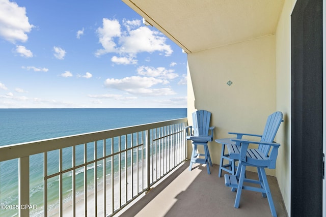 balcony with a beach view and a water view