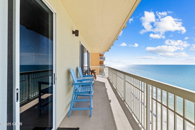 balcony with a water view and a beach view