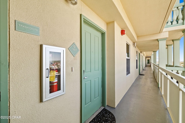 view of exterior entry with stucco siding