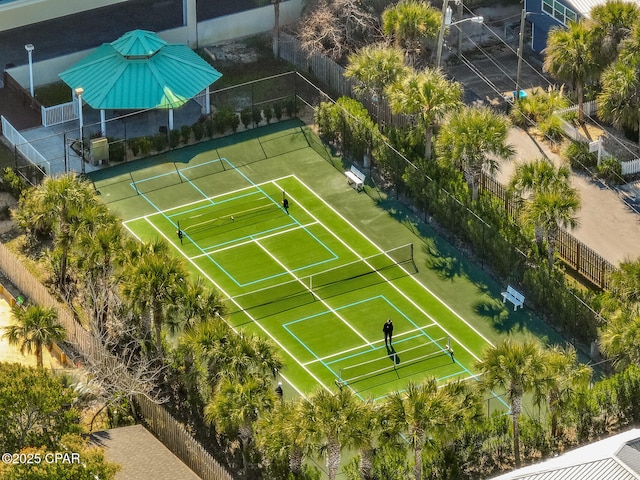 view of tennis court featuring fence