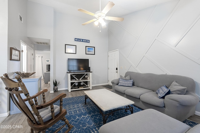 4120 Nova St Unit D, Panama City Beach, FL 32408 - living room featuring wood finished floors, a high ceiling, ceiling fan, and baseboards