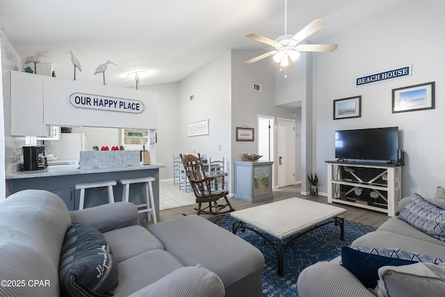 4120 Nova St Unit D, Panama City Beach, FL 32408 - living area featuring ceiling fan, high vaulted ceiling, light wood finished floors, and baseboards