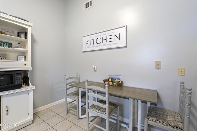 4120 Nova St Unit D, Panama City Beach, FL 32408 - dining space with light tile patterned floors and baseboards