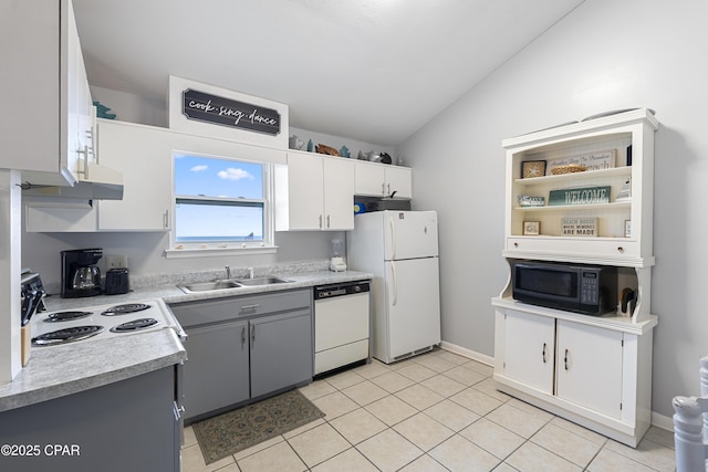 4120 Nova St Unit D, Panama City Beach, FL 32408 - kitchen with white appliances, a sink, lofted ceiling, light countertops, and light tile patterned floors