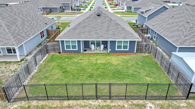 8470 Sun Point Dr, Panama City, FL 32404 - back of property featuring a residential view, a fenced backyard, roof with shingles, and a patio area