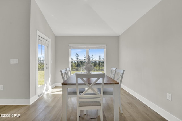 8470 Sun Point Dr, Panama City, FL 32404 - dining area with wood finished floors and vaulted ceiling