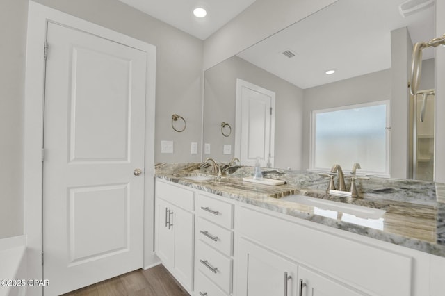 8470 Sun Point Dr, Panama City, FL 32404 - full bath featuring double vanity and wood finished floors