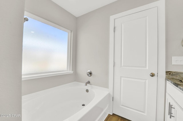8470 Sun Point Dr, Panama City, FL 32404 - bathroom featuring a garden tub and vanity