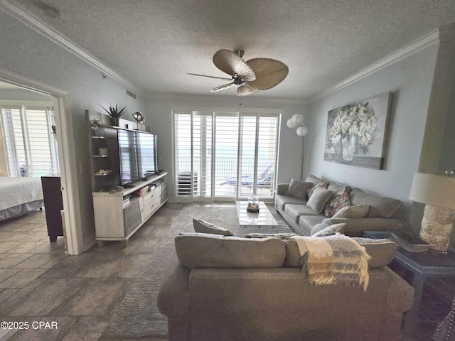 living room with a textured ceiling, crown molding, and stone finish floor