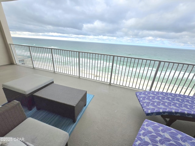 balcony with a water view and a beach view