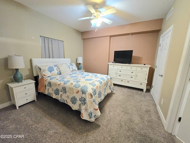 carpeted bedroom with visible vents, baseboards, and ceiling fan