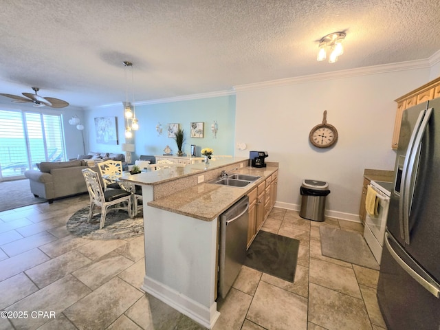 kitchen with a peninsula, ornamental molding, a sink, appliances with stainless steel finishes, and a textured ceiling