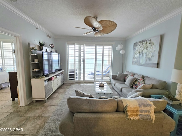 living area with visible vents, a textured ceiling, ceiling fan, and ornamental molding