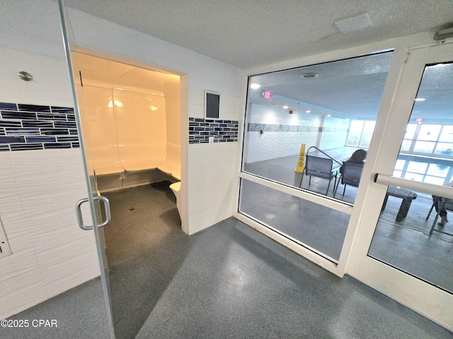 hallway featuring a textured ceiling