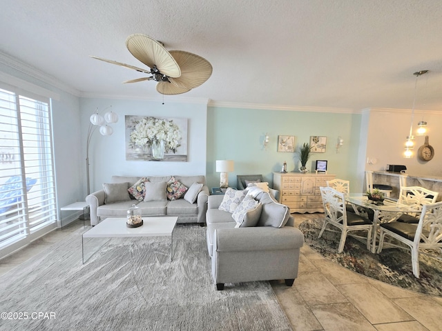 living area with ornamental molding and a ceiling fan