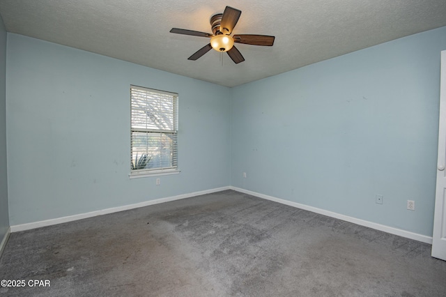 empty room with baseboards and a textured ceiling