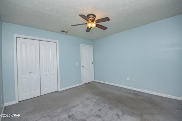 unfurnished bedroom featuring carpet, visible vents, a closet, and baseboards